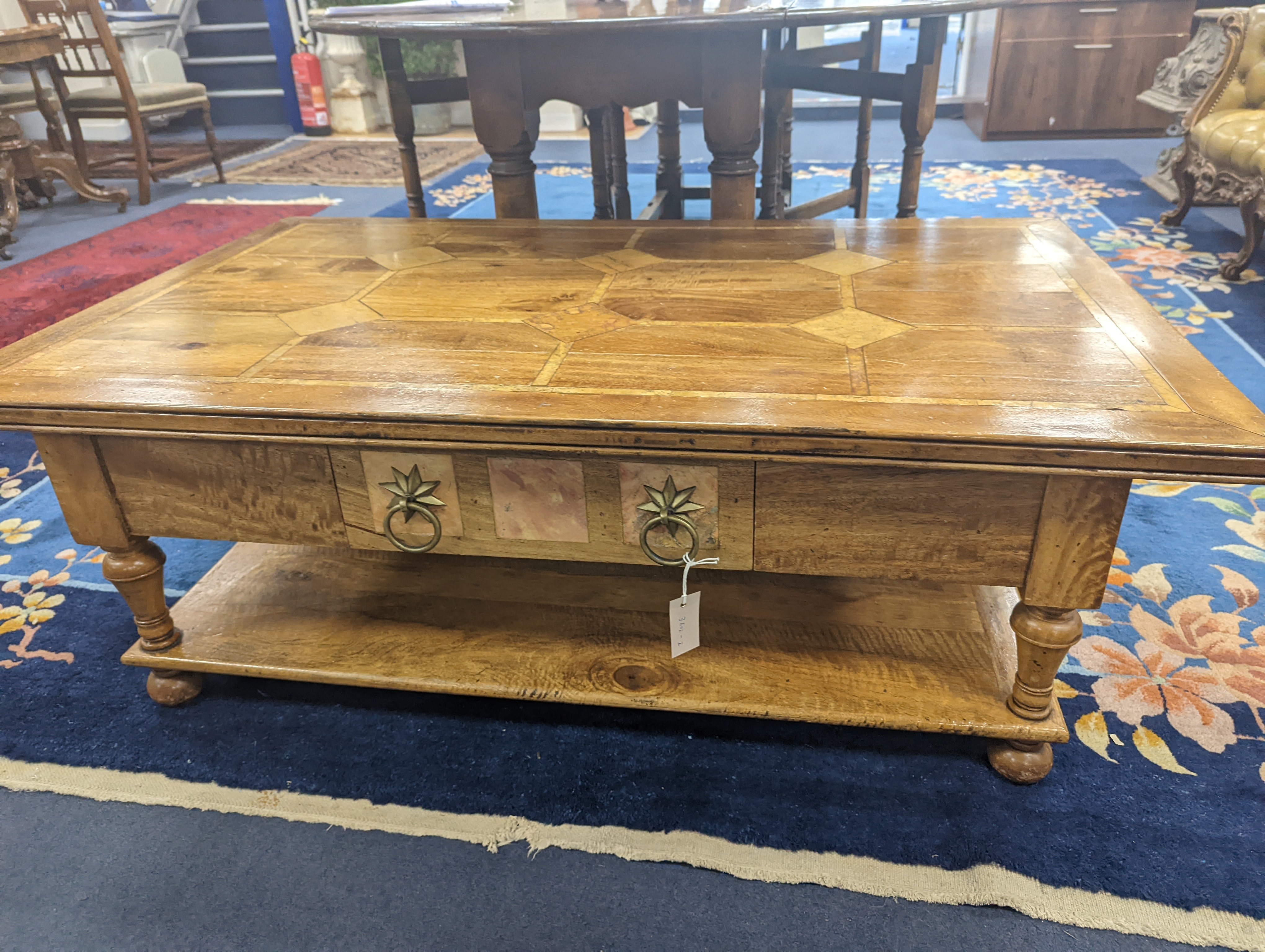 A hardwood and marble inset coffee table, length 130cm, depth 80cm, height 45cm